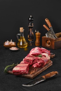 Raw fresh beef short rib stripes on wooden cutting board