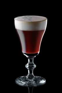 Glass of espresso martini isolated on black background background