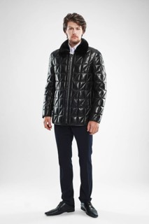 Brutal handsome unshaven man with beard and moustache in waterproof coat with fur collar