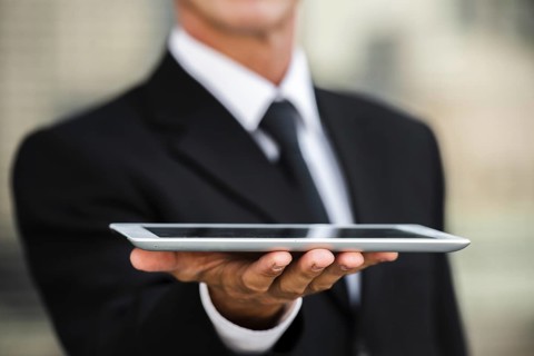 Close up businessman holding tablet hand