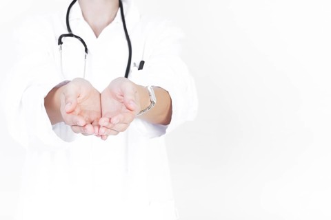 Close up doctor with cupped hands