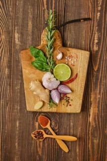 Composition with different spice and seasonings for cooking on wooden cutting board