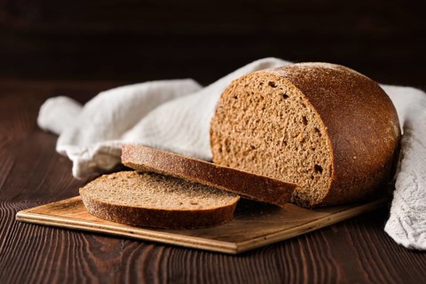 Rue brown bread on cutting board on the table