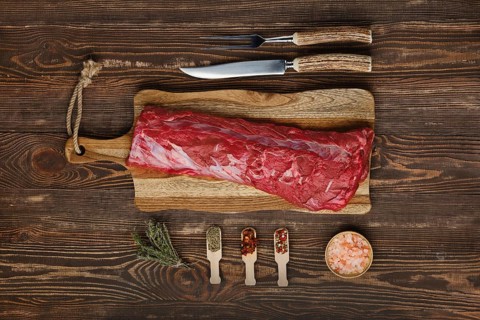 Overhead view of raw fresh beef tenderloin roast with spices