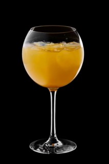 Cold sangria in wine glass isolated on black background