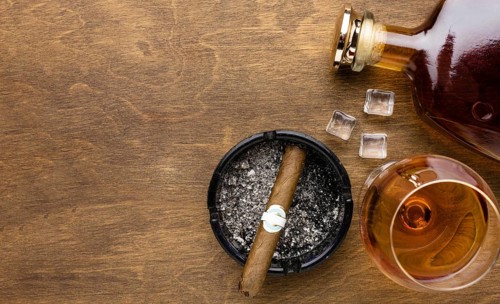Flat lay cognac cigar with copy space