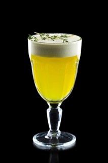Glass of hot ginger grog isolated on black.