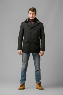 Full length portrait of handsome man in warm woolen coat posing in studio