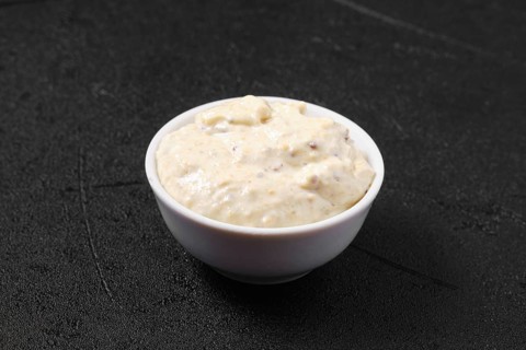 Small bowl with caesar sauce for salad