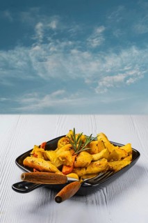 Spicy pumpkin and carrot baked in oven on ceramic plate