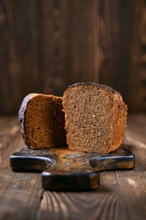 Loaf of artisan rye bread cut on half