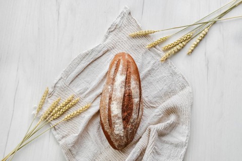 Overhead view of rue bread on light background