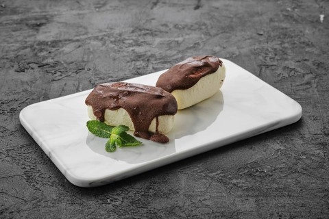 Glazed curd with chocolate on marble plate