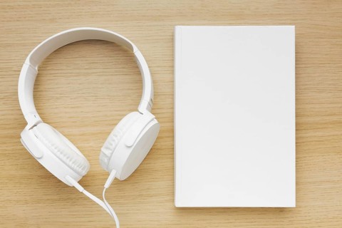 Headphone beside book