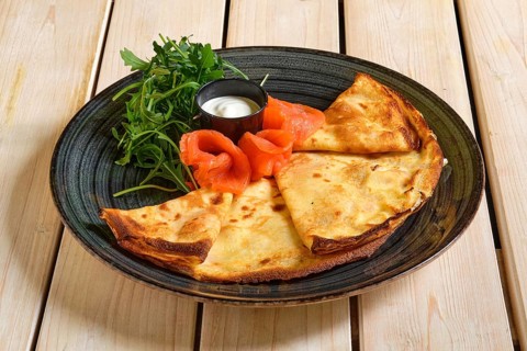 Thin pancakes with salmon and sour cream