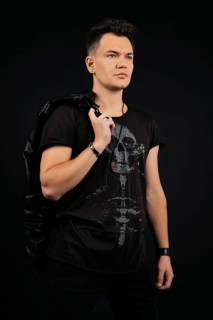 Strong and confident man holding leather jacket over his shoulder