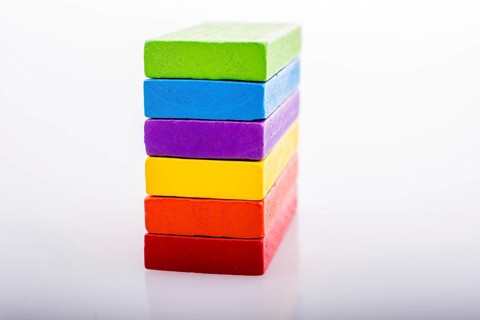 Colorful Domino Blocks in a line on a white background
