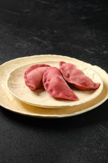 Concept of delivery of semifinished food. Sweet dumplings stuffed with cherry and frozen