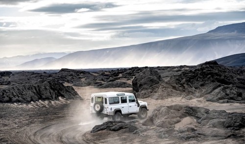 White Land Rover on a dirt road