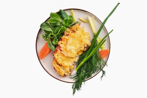 Chopped meat with tomato covered with melted cheese isolated on white background