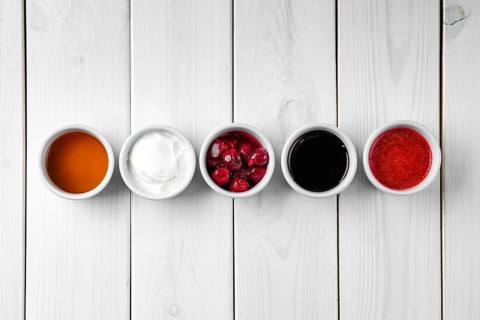 Assortment of different sauce on white wooden table