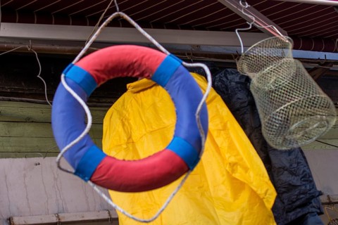 Lifesaver or life preserver with rope around for a drowning person to grab