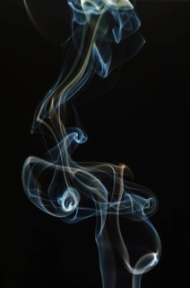 Trajectory of incense smoke in the air showing different shapes. France