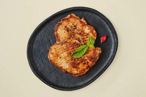 Overhead view of fried chopped pork tenderloin on a plate