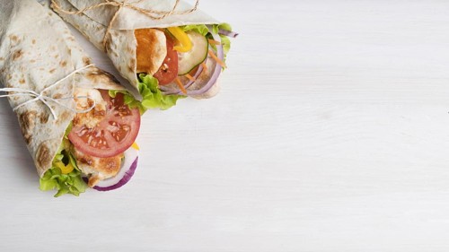 Kebab wrap with meat and vegetables with copy space
