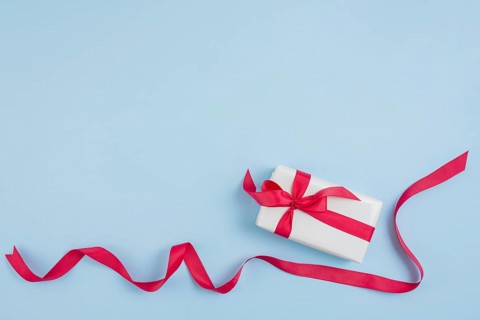 Red ribbon near gift box