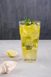 Faceted tall glass with cold citrus lemonade