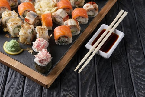 Big set of rolls served on stone plate. Layout for menu