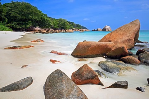Granite rocks and beach of Anse Lazio in the evening