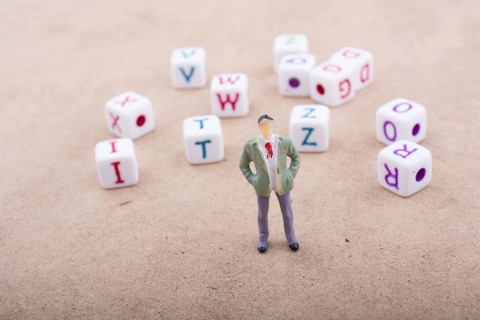 Figurine standing in front of the colorful alphabet letter cubes