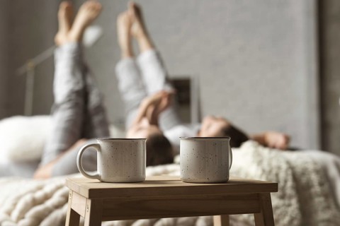Coffee cups table with couple bed