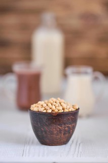 Chocolate milk and soy milk on white wooden table