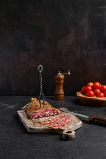 Homemade smoked pork sausage in organic casing on wooden cutting board