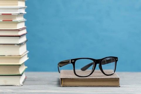 Front view pile books with glasses