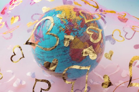 Little model globe under a fabric with heart patterns