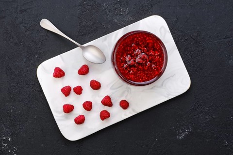 Top view of transparent pot with raspberry jam