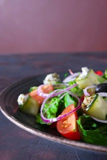 Fresh salad with zucchini stuffed with feta cheese with tomato