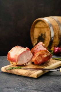 Smoked lamb meat on wooden cutting board