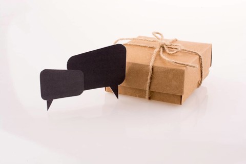 Dialogue boxes near a carton box on a white background