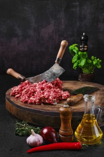 Fresh beef minced meat on wooden chopping stump