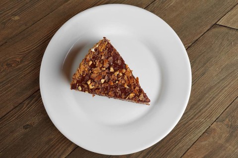 Top view of chocolate sliced cake on wooden table