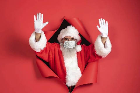 Man santa costume with medical mask coming out paper