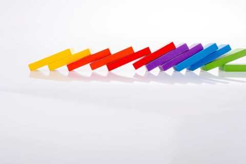 Colorful Domino Blocks in a line on a white background