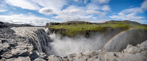 Canyon with falling water masses and rainbow
