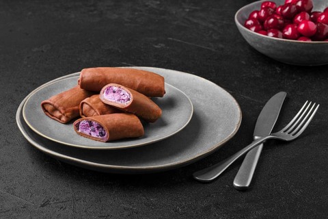 Thin chocolate pancakes stuffed with curd