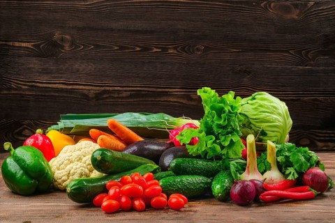 Assortment of fresh vegetables on dark wooden background